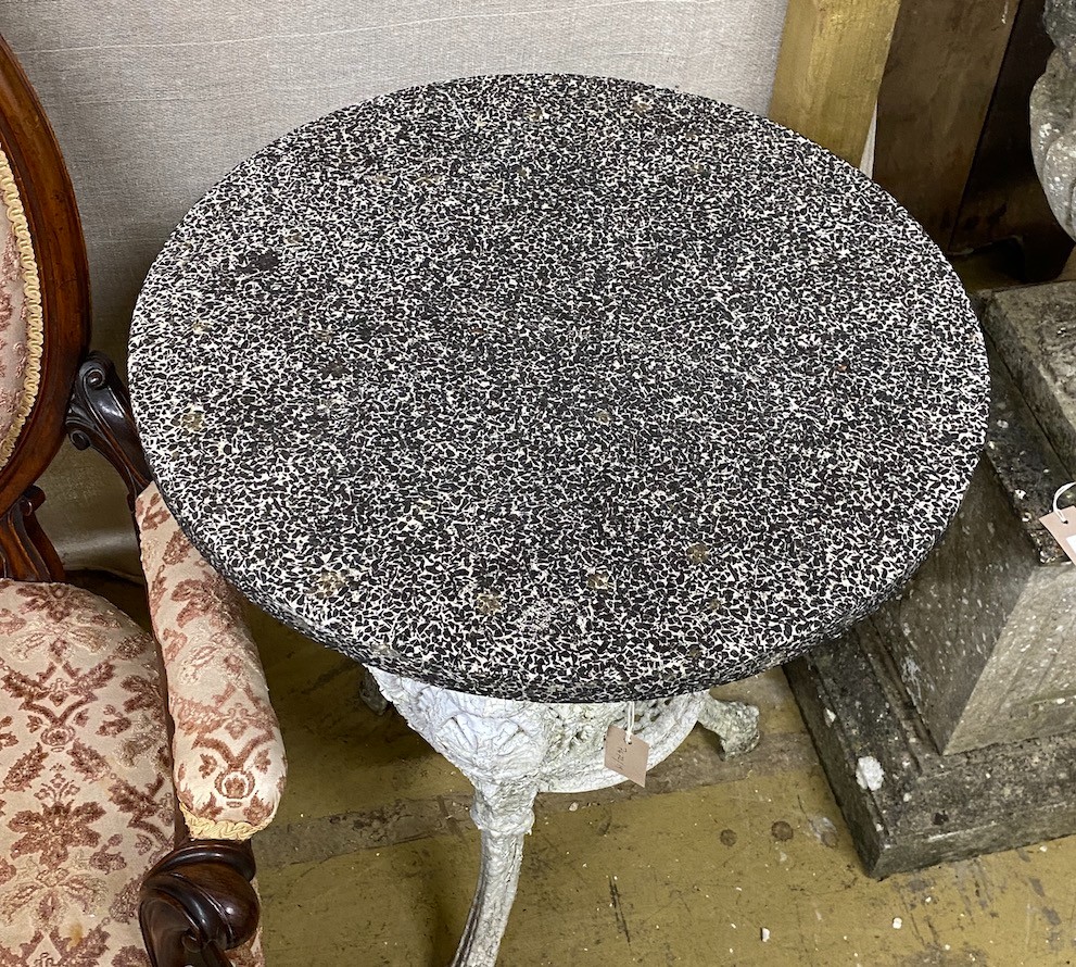 A Victorian cast iron circular garden table with weathered stone top, diameter 61cm, height 72cm